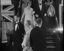 People in Evening Dress Walking Down Stairs, 1931. Creator: British Pathe Ltd