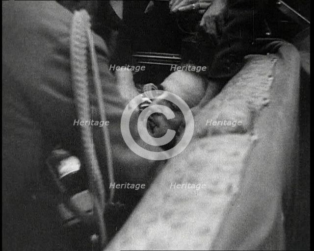 People Inspecting a Corpse, 1934. Creator: British Pathe Ltd.