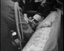 People Inspecting a Corpse, 1934. Creator: British Pathe Ltd