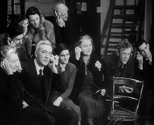 People Listening to Parents Calling Evacuee Children in America Over the Radio, 1940. Creator: British Pathe Ltd