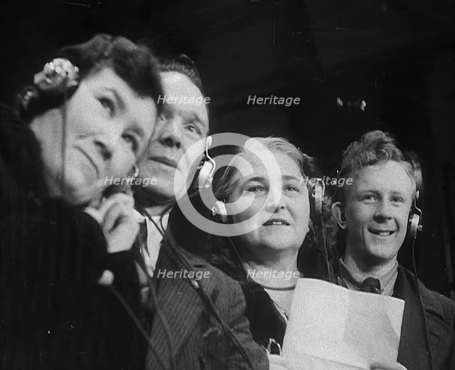People Listening to Parents Calling Evacuee Children in America Over the Radio, 1940. Creator: British Pathe Ltd.