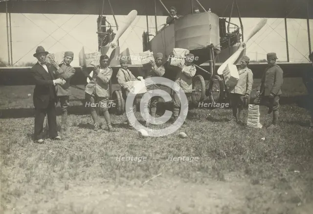 People loading supplies on airplane, 1919-1930. Creator: Fédèle Azari.