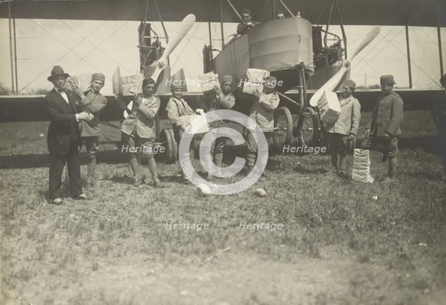 People loading supplies on airplane, 1919-1930. Creator: Fédèle Azari.