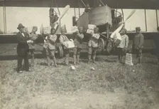 People loading supplies on airplane, 1919-1930. Creator: Fédèle Azari