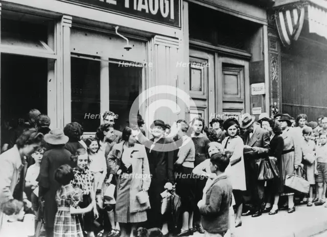 People queuing outside a dairy shop, German-occupied Paris, 26 July 1940. Artist: Unknown