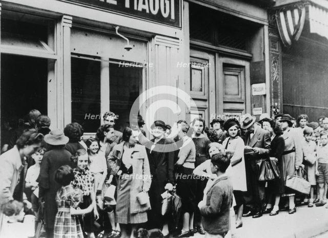 People queuing outside a dairy shop, German-occupied Paris, 26 July 1940. Artist: Unknown