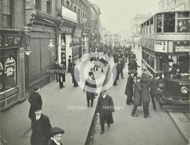 People rushing to get on a trolley bus at 7.05 am, Tooting Broadway, London, April 1912. Artist: Unknown.