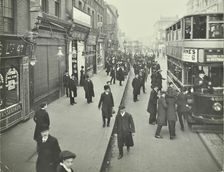 People rushing to get on a trolley bus at 7.05 am, Tooting Broadway, London, April 1912