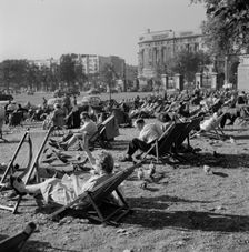 People relaxing on deck chairs amongst the pigeons in Hyde Park, London, 1960-1970. Creator: John Gay