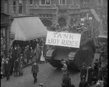People Riding on Top of a Tank Down the Street. The Tank Bears a Sign Reading Tank Joy Rides 1920 Creator: British Pathe Ltd