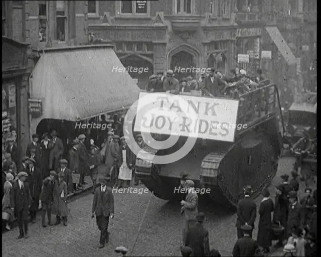 People Riding on Top of a Tank Down the Street. The Tank Bears a Sign Reading 'Tank Joy Rides', 1920 Creator: British Pathe Ltd.