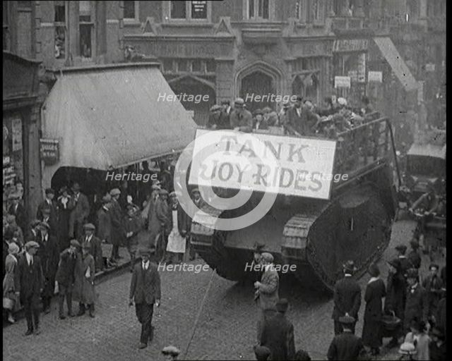 People Riding on Top of a Tank Down the Street. The Tank Bears a Sign Reading 'Tank Joy Rides', 1920 Creator: British Pathe Ltd.