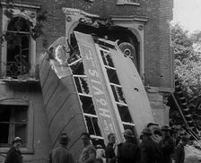People Standing Next to a Bombed Out Bus, 1940. Creator: British Pathe Ltd