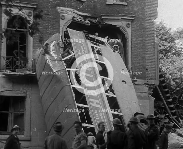 People Standing Next to a Bombed Out Bus, 1940. Creator: British Pathe Ltd.