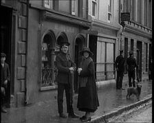 People Walking Along a Desolate Street in Ireland, 1921. Creator: British Pathe Ltd