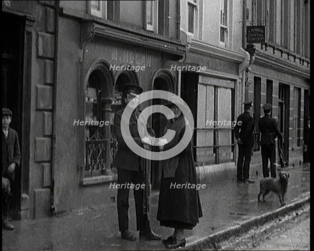 People Walking Along a Desolate Street in Ireland, 1921. Creator: British Pathe Ltd.