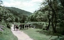 People walking alongside a river in Dovedale, Derbyshire, c1955-1965. Creator: Arthur Charles Kirby Ware