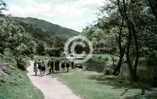 People walking alongside a river in Dovedale, Derbyshire, c1955-1965. Creator: Arthur Charles Kirby Ware.
