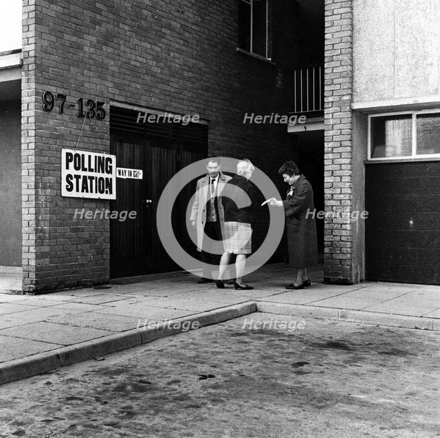 People walking into a polling station, London, 1964. Creator: Henry Grant.