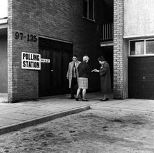 People walking into a polling station, London, 1964. Creator: Henry Grant