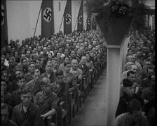 People Watching an Orchestra with Nazi Flags on the Walls, 1937. Creator: British Pathe Ltd