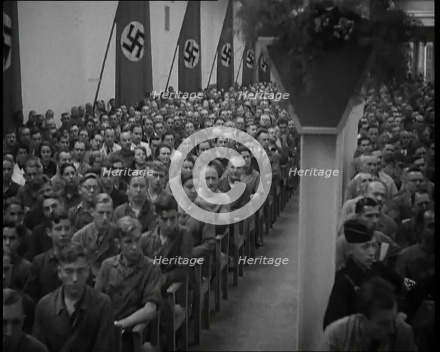 People Watching an  Orchestra with Nazi Flags on the Walls, 1937. Creator: British Pathe Ltd.