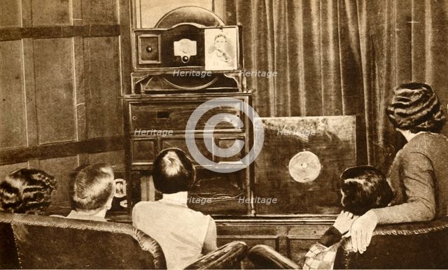 People watching an early television broadcast, c1930, (1933). Creator: Unknown.