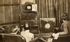 People watching an early television broadcast, c1930, (1933). Creator: Unknown