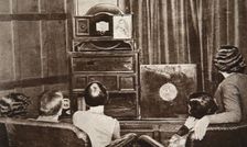 People watching an early television transmission, c1920s. Creator: Unknown