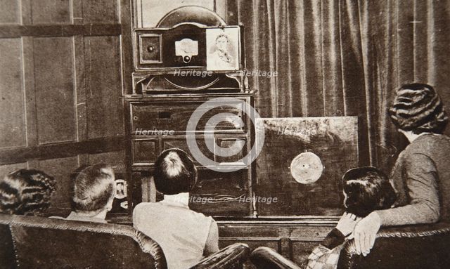 People watching an early television transmission, c1920s. Creator: Unknown.