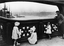 People watching the Thames from Tower Bridge, City of London, c1930. Creator: George Davison Reid