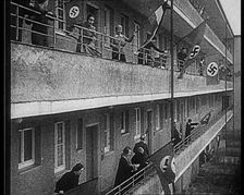 People Waving Flags of the Nazi Party and German Flags of 1867-1918 from Balconies, 1933. Creator: British Pathe Ltd