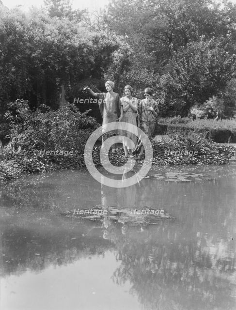 People wearing masks made by W.T. Benda, 1925 Sept. 20. Creator: Arnold Genthe.