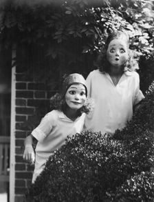 People wearing masks made by W.T. Benda, 1925 Sept. 20. Creator: Arnold Genthe