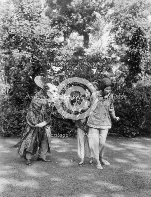 People wearing masks made by W.T. Benda, 1925 Sept. 20. Creator: Arnold Genthe.