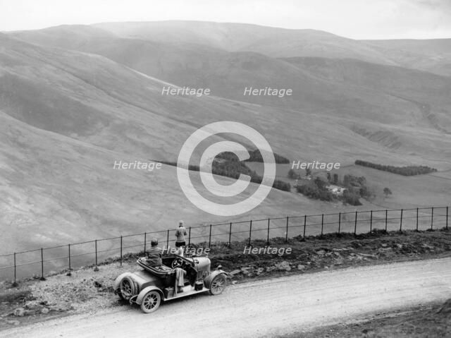 People with a Morris Cowley at the Devil's Beef Tub, Scotland, (c1930s?). Artist: Unknown