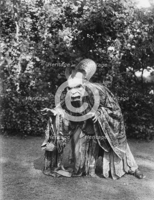 Person wearing a mask made by W.T. Benda, 1925 Sept. 20. Creator: Arnold Genthe.