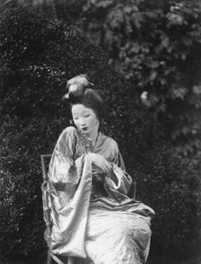 Person wearing a mask made by W.T. Benda, 1925 Sept. 20. Creator: Arnold Genthe