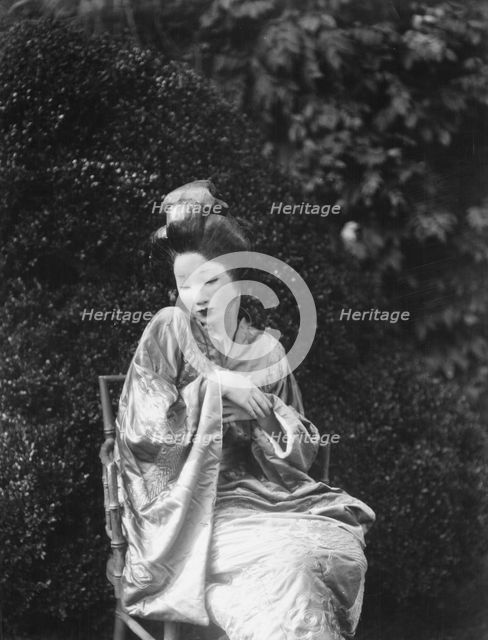 Person wearing a mask made by W.T. Benda, 1925 Sept. 20. Creator: Arnold Genthe.