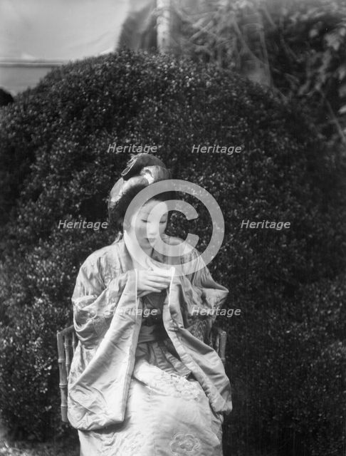 Person wearing a mask made by W.T. Benda, 1925 Sept. 20. Creator: Arnold Genthe.