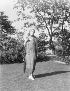 Person wearing a mask made by W.T. Benda, 1925 Sept. 20. Creator: Arnold Genthe