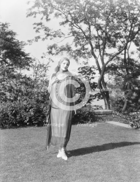 Person wearing a mask made by W.T. Benda, 1925 Sept. 20. Creator: Arnold Genthe.