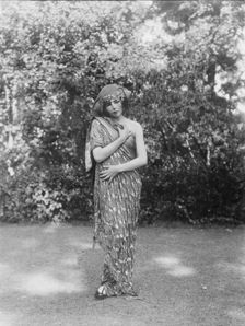 Person wearing a mask made by W.T. Benda, 1925 Sept. 20. Creator: Arnold Genthe