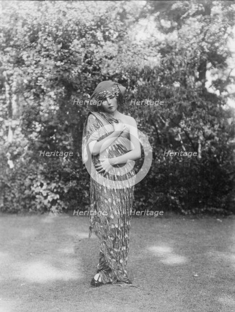 Person wearing a mask made by W.T. Benda, 1925 Sept. 20. Creator: Arnold Genthe.