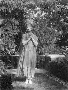 Person wearing a mask made by W.T. Benda, 1925 Sept. 20. Creator: Arnold Genthe
