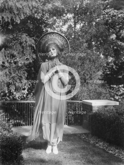 Person wearing a mask made by W.T. Benda, 1925 Sept. 20. Creator: Arnold Genthe.