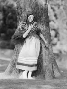 Person wearing a mask made by W.T. Benda, 1925 Sept. 20. Creator: Arnold Genthe