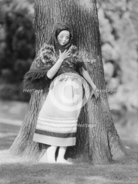 Person wearing a mask made by W.T. Benda, 1925 Sept. 20. Creator: Arnold Genthe.
