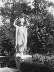 Person wearing a mask made by W.T. Benda, 1925 Sept. 20. Creator: Arnold Genthe
