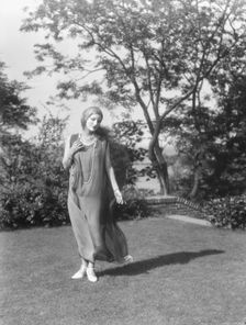Person wearing a mask made by W.T. Benda, 1925 Sept. 20. Creator: Arnold Genthe